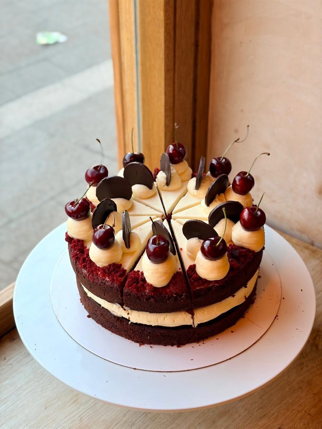 Layer cake topped with cherries