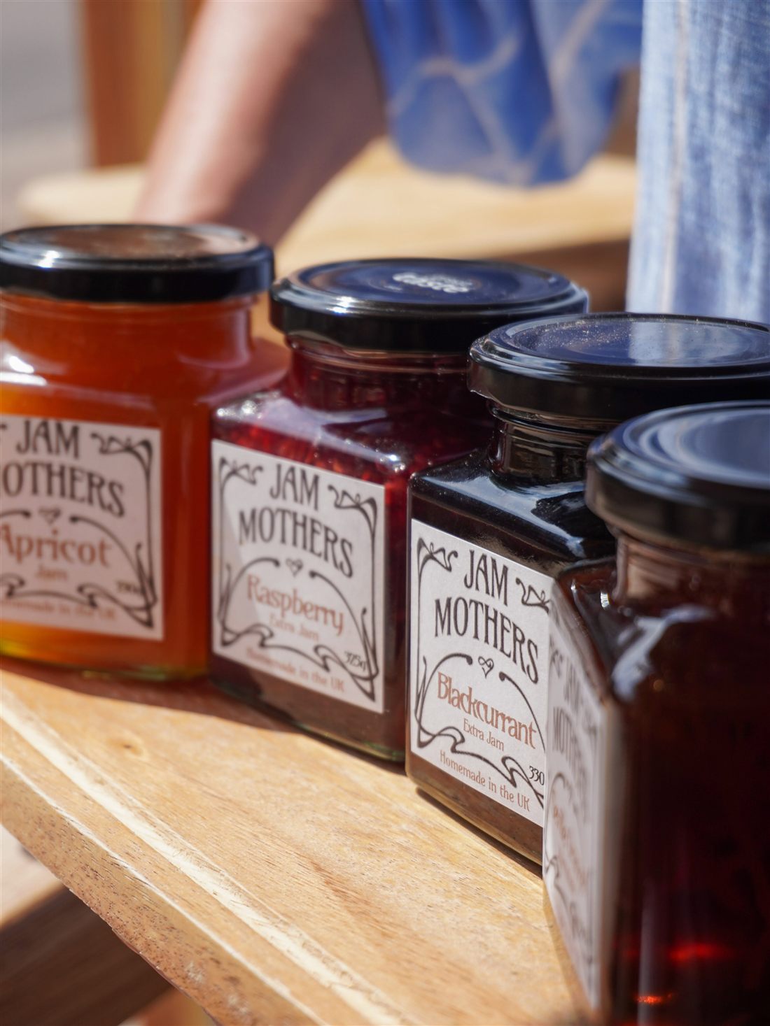Jars of Jam Mother's preserves on a shelf